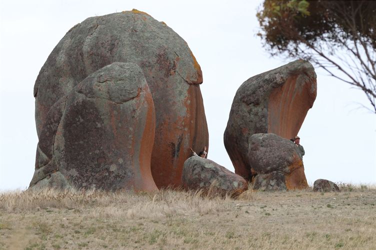 Visitors peeking out between the granite boulders