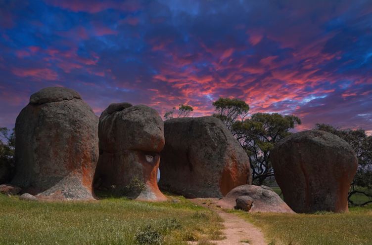Silent sentinels: granite pillars under a sunset sky